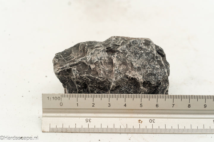 Kleine Dark Hell Stone S101 van Hardscape.nl met ruwe, donkere textuur voor tuin- of opritdecoratie.